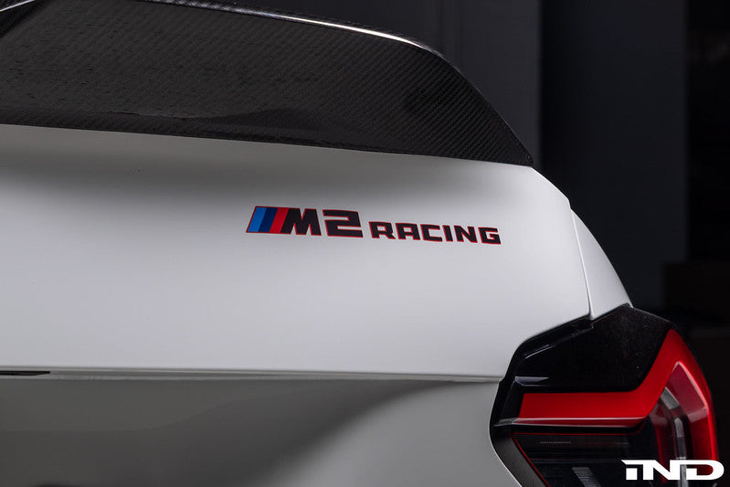 Rear view of the BMW M2 Racing showing the M2 Racing badge mounted on the trunk lid of the factory customer race car.