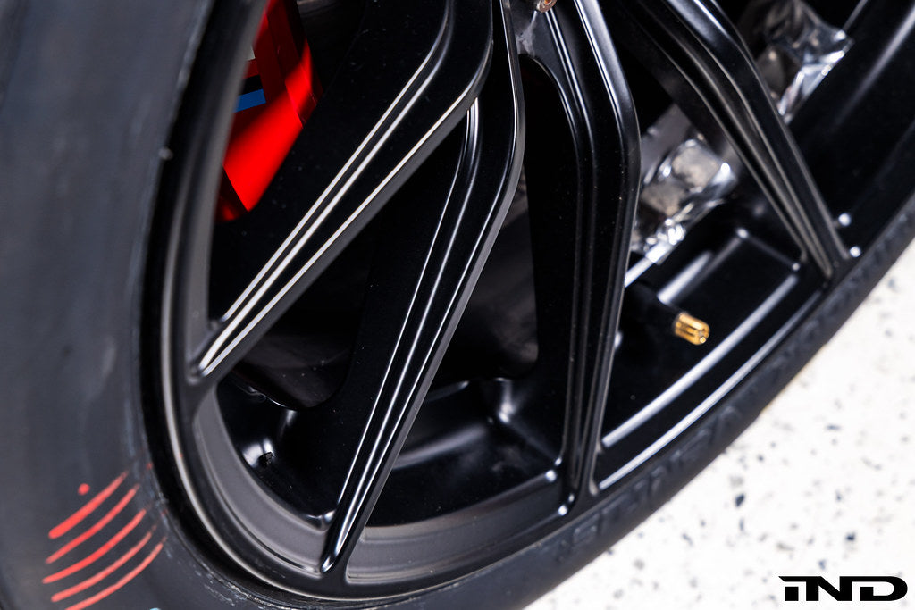 BMW Motorsport G87 M2 Racing black 18x10 wheel set installed on a BMW M2 Racing race car, featuring lightweight motorsport construction, track-focused fitment, and factory BMW Motorsport engineering.