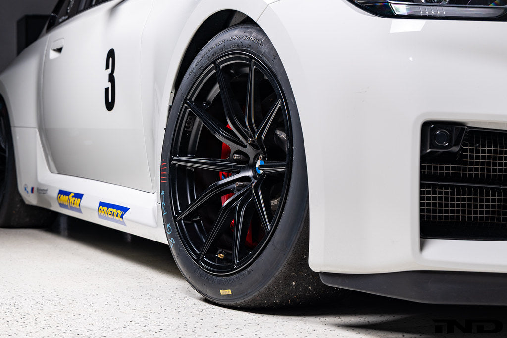 BMW Motorsport G87 M2 Racing black 18x10 wheel set installed on a BMW M2 Racing race car, featuring lightweight motorsport construction, track-focused fitment, and factory BMW Motorsport engineering.