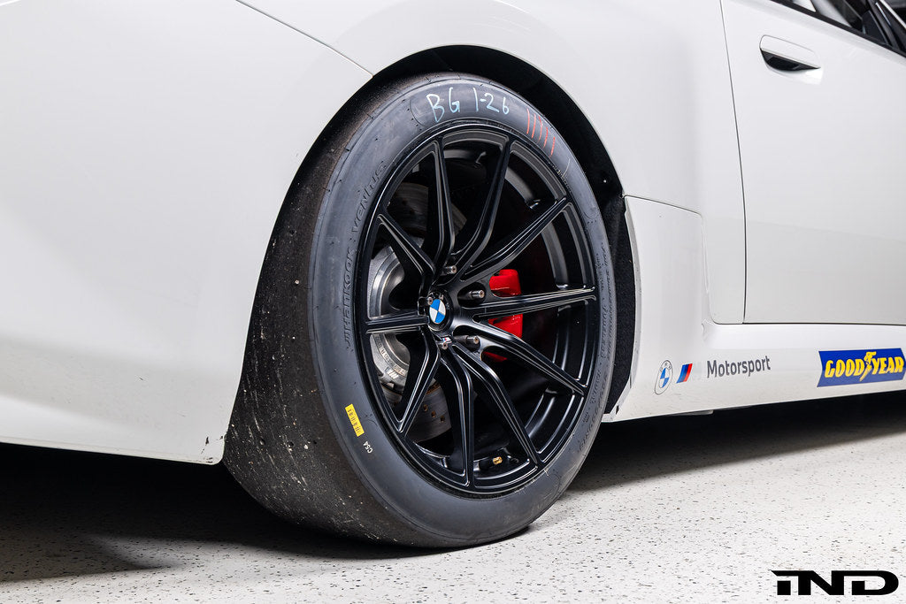 BMW Motorsport G87 M2 Racing black 18x10 wheel set installed on a BMW M2 Racing race car, featuring lightweight motorsport construction, track-focused fitment, and factory BMW Motorsport engineering.
