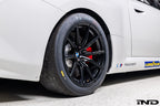 BMW Motorsport G87 M2 Racing black 18x10 wheel set installed on a BMW M2 Racing race car, featuring lightweight motorsport construction, track-focused fitment, and factory BMW Motorsport engineering.