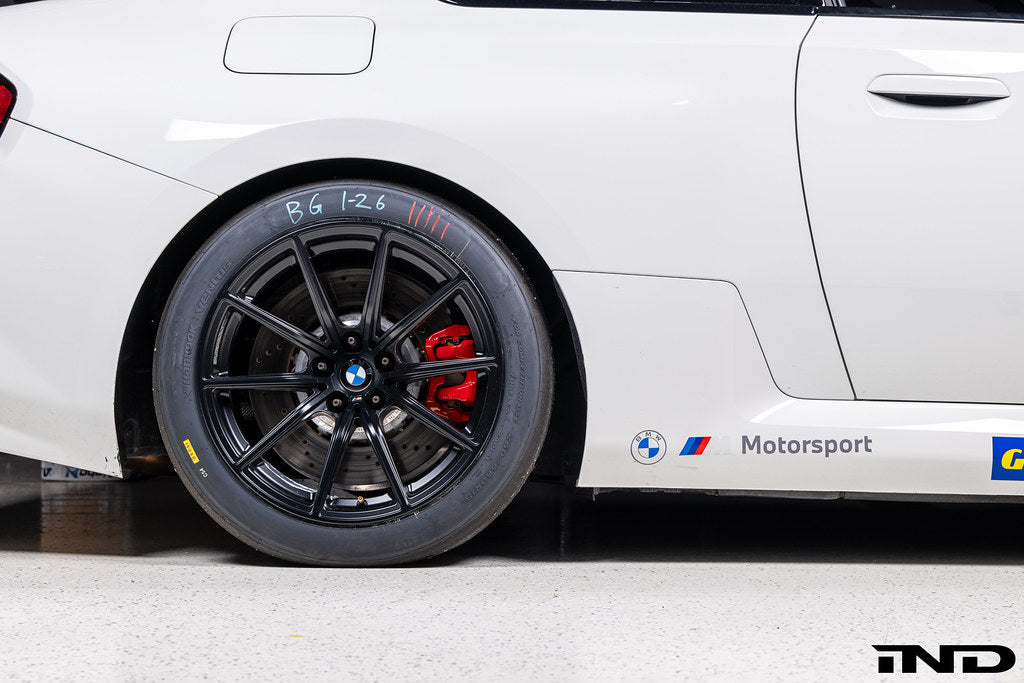 BMW Motorsport G87 M2 Racing black 18x10 wheel set installed on a BMW M2 Racing race car, featuring lightweight motorsport construction, track-focused fitment, and factory BMW Motorsport engineering.