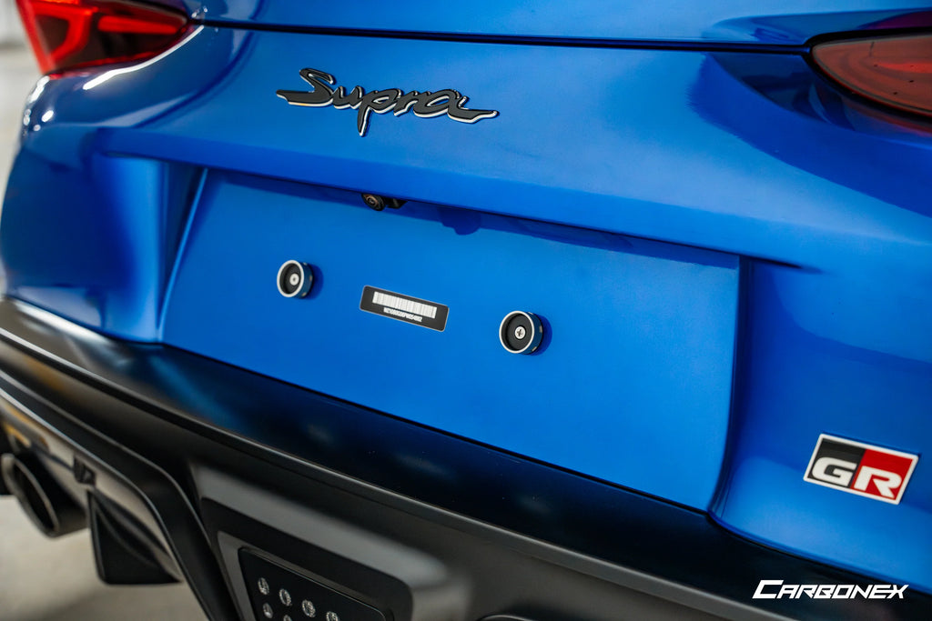 Carbonex A9X GR Supra magnetic rear license plate mount attached to the vehicle's exterior.