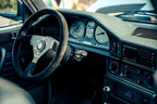 CANchecked MFD28 Gen2 2.8-inch multi-function display installed in the dashboard air vent of a left-hand drive BMW E28 M5 and 5-Series, displaying real-time vehicle data with OEM-style fitment.