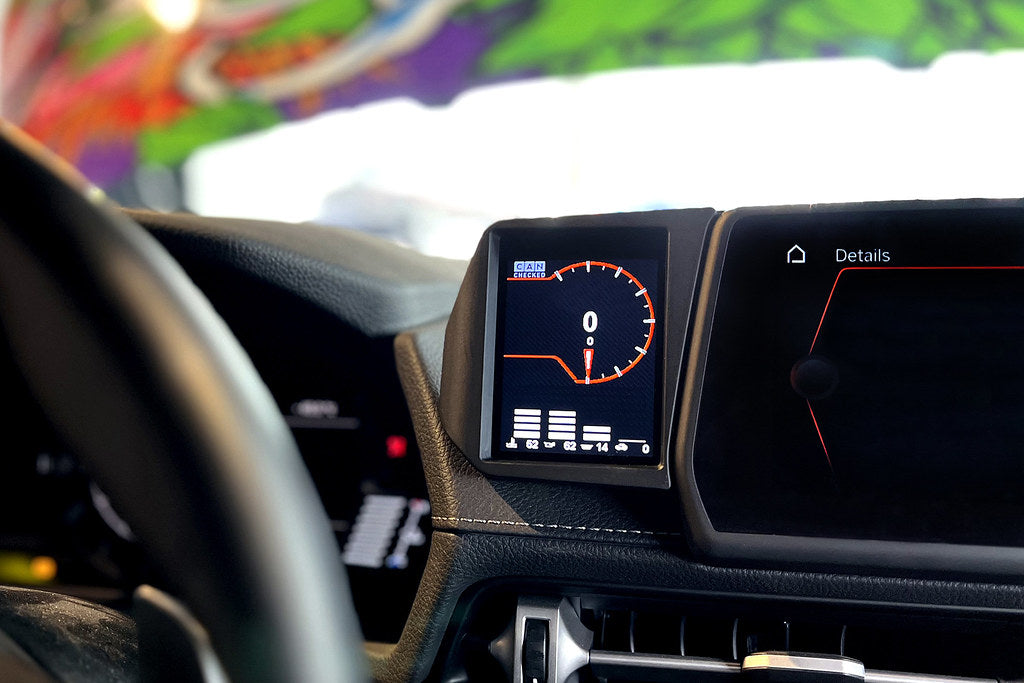 CANchecked MFD32 Gen2 3.2-inch multi-function display installed in a Toyota A90 MK5 GR Supra interior, providing touchscreen control, real-time vehicle diagnostics, performance monitoring, and advanced CAN bus data integration through an OEM-style installation.