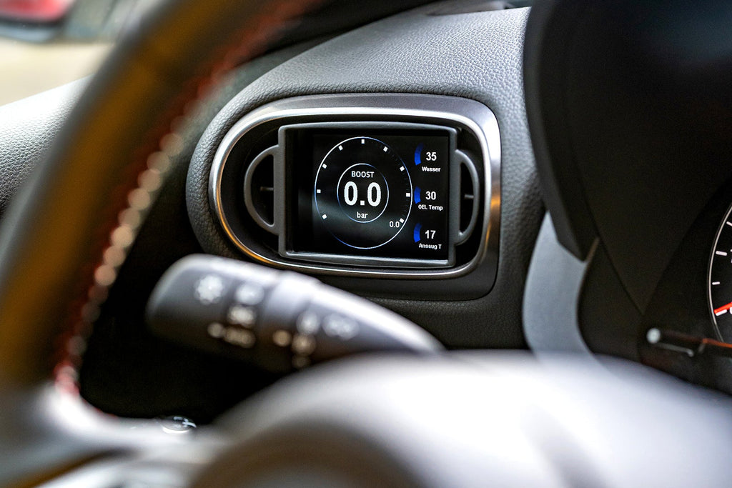 CANchecked MFD32 Gen2 3.2-inch multi-function display installed in a left-hand drive Toyota XP210 Yaris with standalone ECU integration, displaying real-time engine and vehicle data.