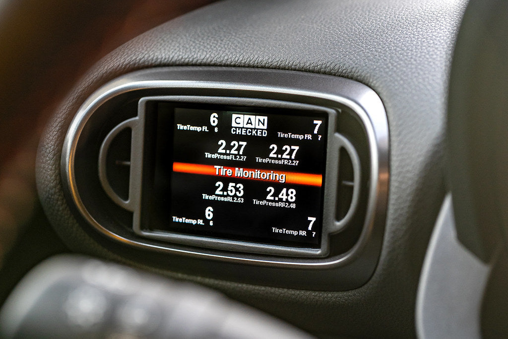 CANchecked MFD32 Gen2 3.2-inch multi-function display installed in a left-hand drive Toyota XP210 Yaris Pre-Facelift, displaying real-time engine and vehicle data with OEM-style dashboard fitment.