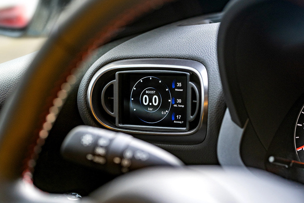 CANchecked MFD32 Gen2 3.2-inch multi-function display installed in a left-hand drive Toyota XP210 Yaris Pre-Facelift, displaying real-time engine and vehicle data with OEM-style dashboard fitment.