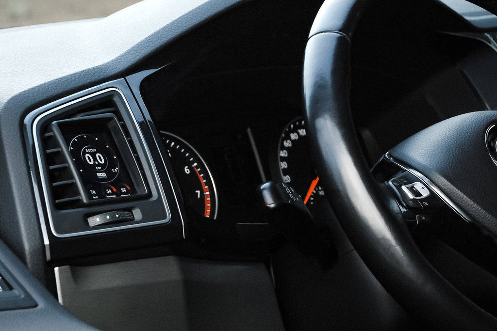 CANchecked MFD28 Gen2 2.8-inch multi-function display installed in a left-hand drive Volkswagen Bus T6, displaying real-time engine and vehicle data with OEM-style dashboard fitment.
