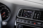 CANchecked MFD32 Gen2 3.2-inch multi-function display installed in a left-hand drive Volkswagen MK5 Polo GTI, displaying real-time engine and vehicle data with OEM-style dashboard fitment.