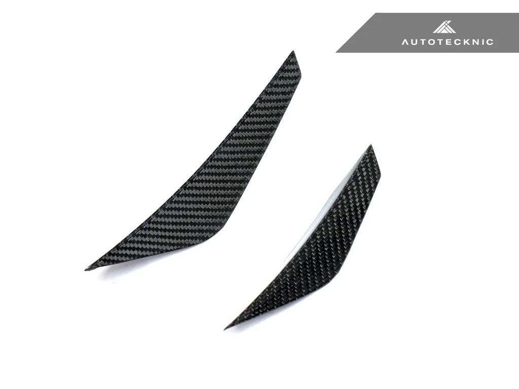 AutoTecknic G8X M3 / M4 dry carbon canard set installed on the exterior of a vehicle, showcasing aerodynamic performance.