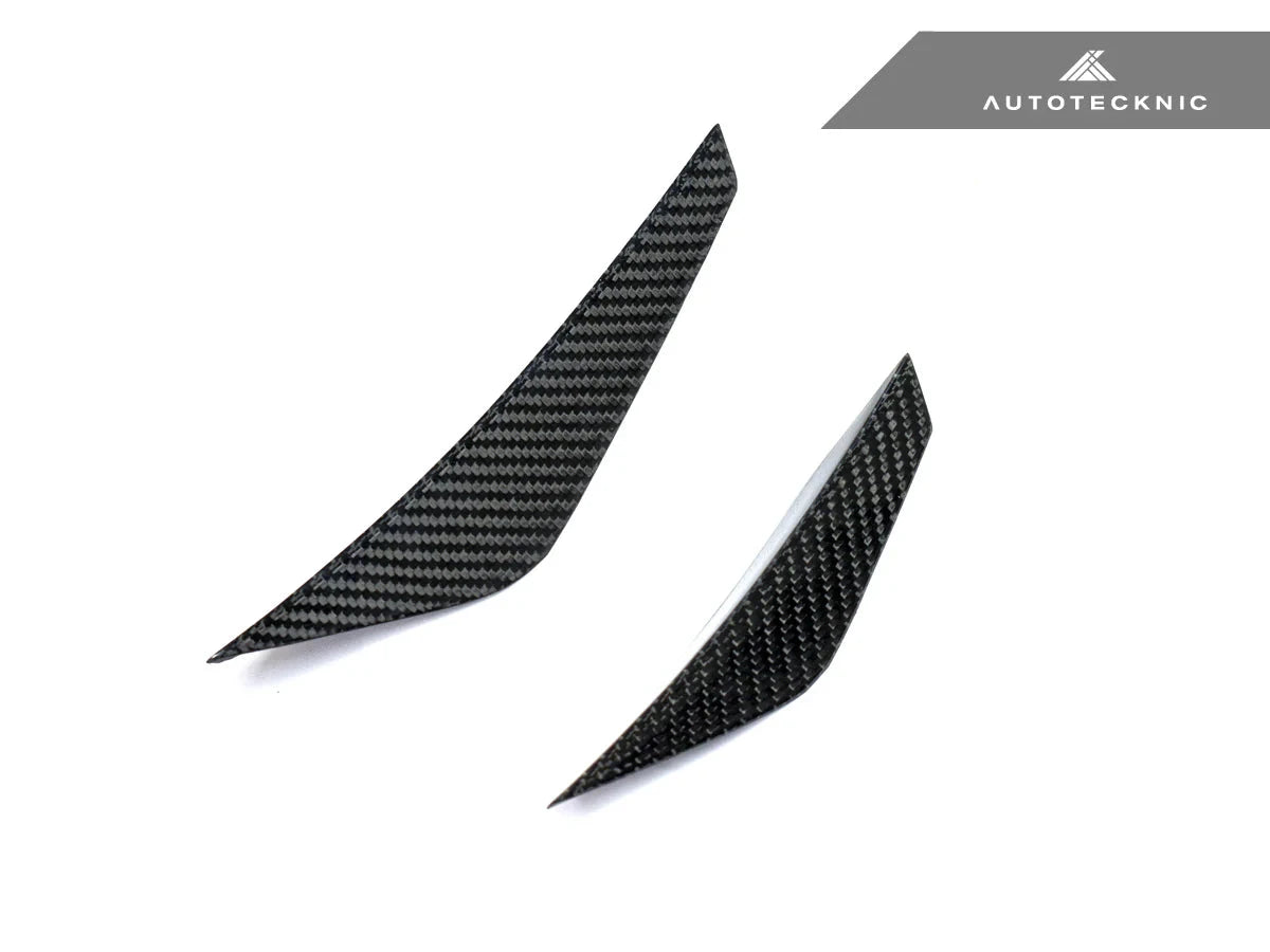 AutoTecknic G8X M3 / M4 dry carbon canard set installed on the exterior of a vehicle, showcasing aerodynamic performance.
