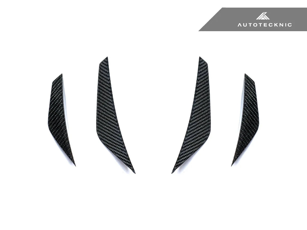 AutoTecknic G8X M3 M4 dry carbon canard set installed on the exterior of a vehicle, showcasing aerodynamic enhancements.
