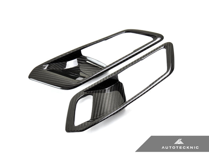AutoTecknic G8X M3 M4 dry carbon interior door handle trim set on car door panel, showcasing sleek, lightweight carbon fiber design