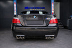 Eisenmann valved stainless steel exhaust installed on BMW E60 M5 highlighting quad tips and performance rear mufflers