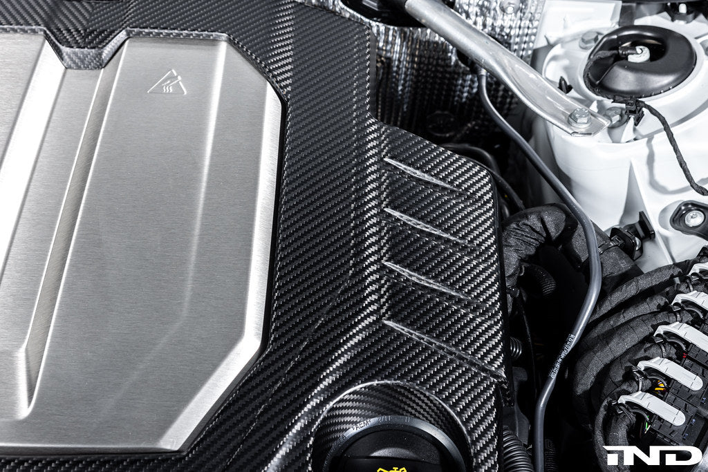 Eventuri black matte carbon engine cover installed on Audi C8 RS6 and RS7 exterior, showcasing sleek, high-performance design.