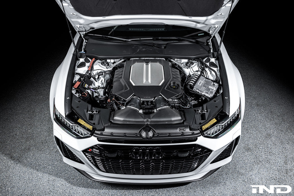 Eventuri black matte carbon engine cover installed on Audi C8 RS6 and RS7 exterior, showcasing sleek carbon fiber design.