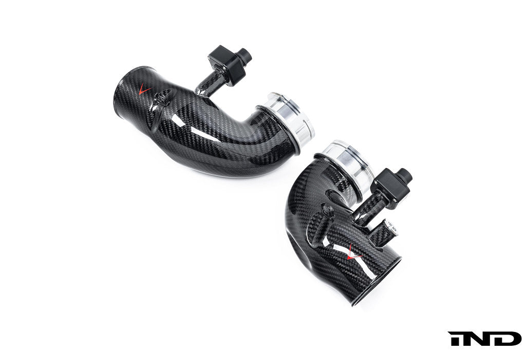 Overhead 3/4 view of a pair of Eventuri's G9X M5 S68 Carbon Turbo Inlets in gloss finish on a white background