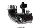 Close-up of Eventuri carbon turbo inlet set for BMW G90 G99 M5 S68, showcasing glossy fittings and high-performance design.