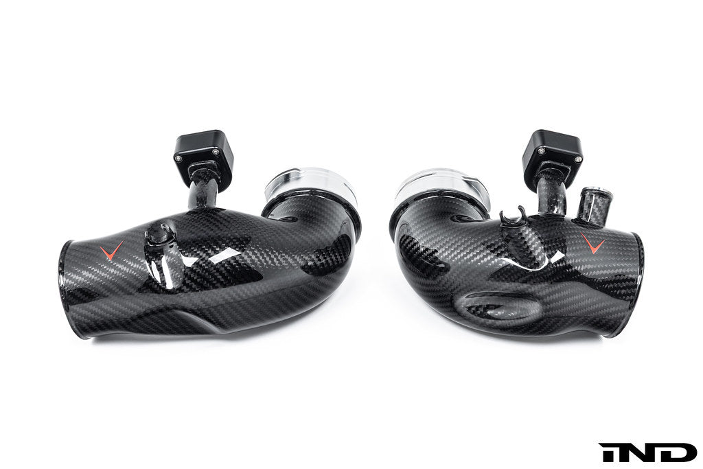 Eventuri carbon turbo inlet set for BMW G90 G99 M5 S68, showcasing glossy black carbon fiber components on a performance engine.