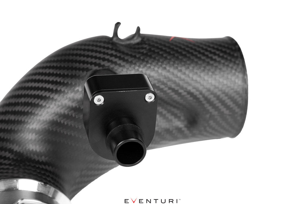 Close-up of matte carbon turbo inlet set for BMW G90 G99 M5 (S68) by Eventuri, showing detailed fitting and performance design.