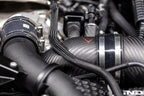 Close-up of Eventuri carbon turbo inlet set installed on BMW G90 G99 M5 (S68) showing matte finish and detailed performance components.