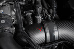 Close-up of matte carbon turbo inlet set installed on BMW G90 G99 M5 S68 by Eventuri, showcasing performance engine components.
