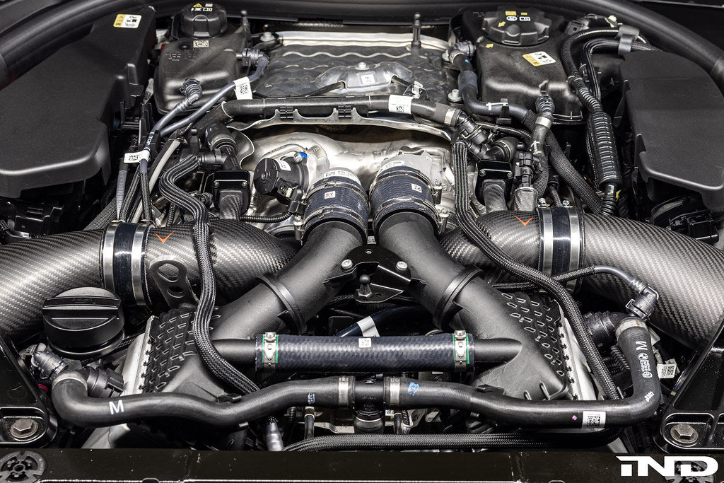 Eventuri BMW G90 G99 M5 S68 carbon turbo inlet set installed, showcasing matte finish and performance-focused design.