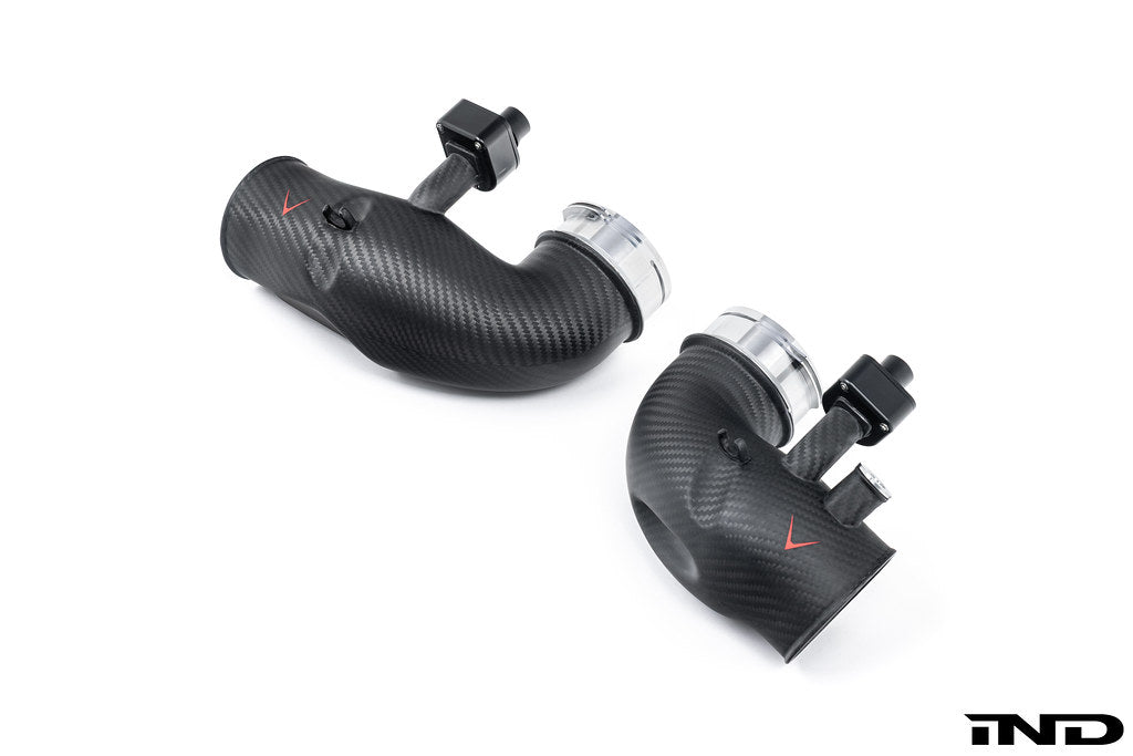 Overhead 3/4 view of a pair of Eventuri's G9X M5 S68 Carbon Turbo Inlets in matte finish on a white background