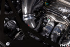 Close-up of Eventuri carbon turbo inlet set installed on F9X X5M, X6M, G09 XM, and M60i LCI performance SUV engine.