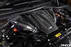 Eventuri F9X X5M X6M G09 XM M60i LCI carbon turbo inlet set installed on engine, showcasing sleek black carbon fiber components.