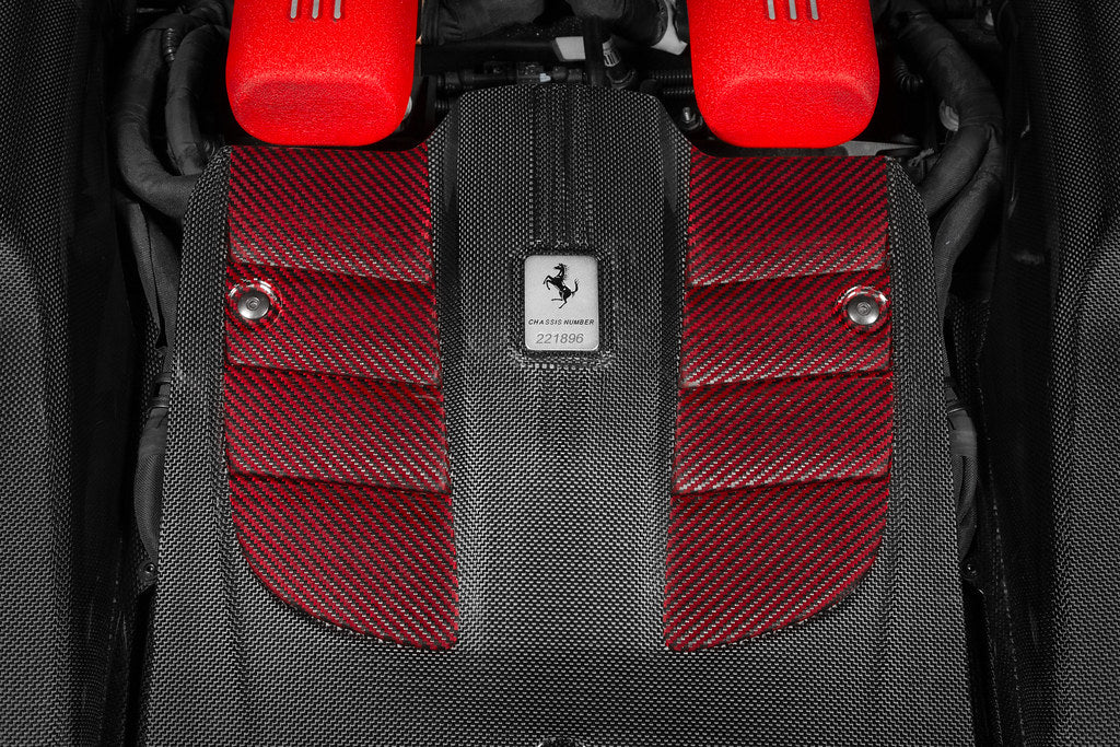 Close-up of Eventuri Ferrari F12 Berlinetta carbon intake system installed on engine with detailed carbon fiber components.