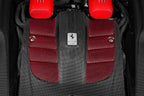 Close-up of Eventuri Ferrari F12 Berlinetta carbon intake system installed on engine with detailed carbon fiber components.