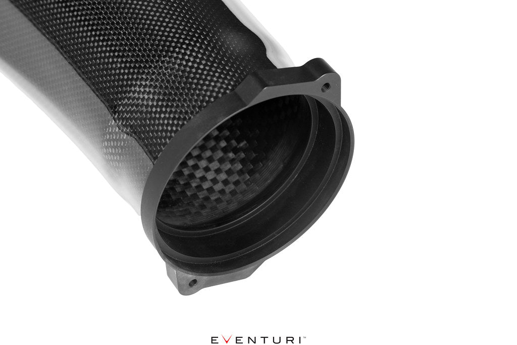 Close-up of Eventuri Ferrari F12 carbon intake system black aluminum inlet flange on white background