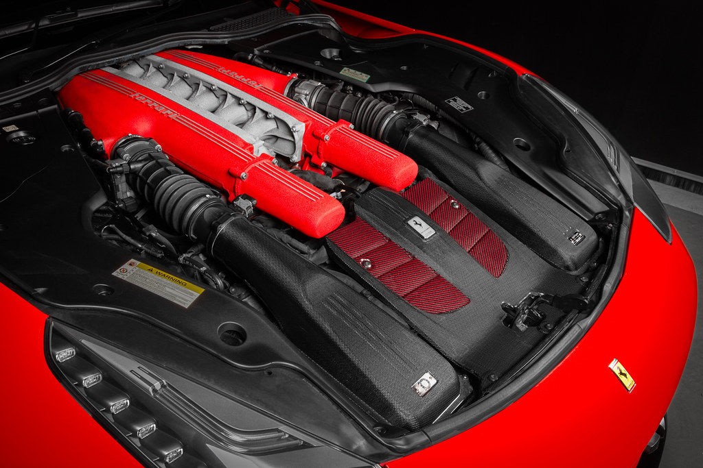 Eventuri Ferrari F12 Berlinetta carbon intake system installed, showing sleek black carbon fiber components from a reverse angle.
