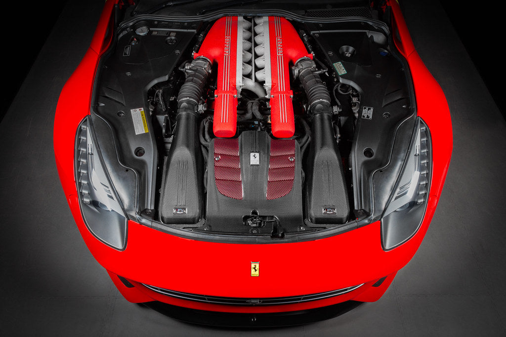Red Ferrari car with open hood showing Eventuri carbon intake system installed