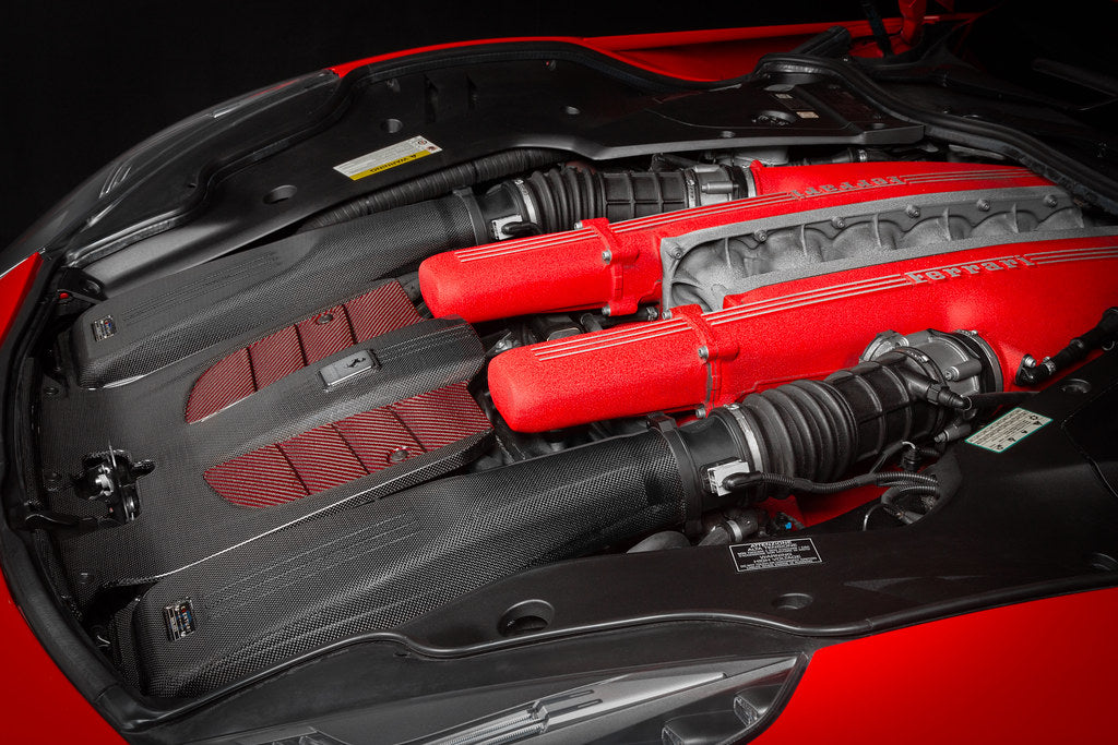 Close-up right angle of red Ferrari F12 engine bay showing Eventuri carbon intake system installed