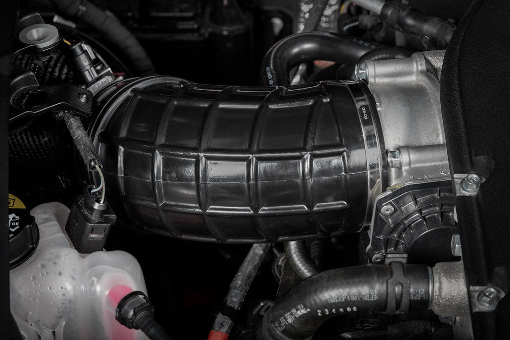 Eventuri Lotus Emira V6 black carbon intake system installed, showcasing its sleek performance design and high-quality materials.