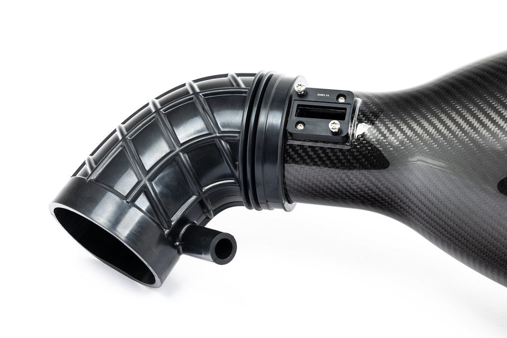 Eventuri Lotus Emira V6 black carbon intake system installed, showcasing sleek performance design on a white background.