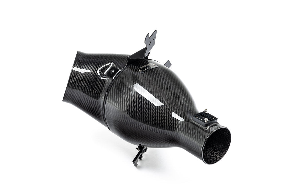 Eventuri Lotus Emira V6 black carbon intake system installed, showcasing sleek performance-oriented design on white background