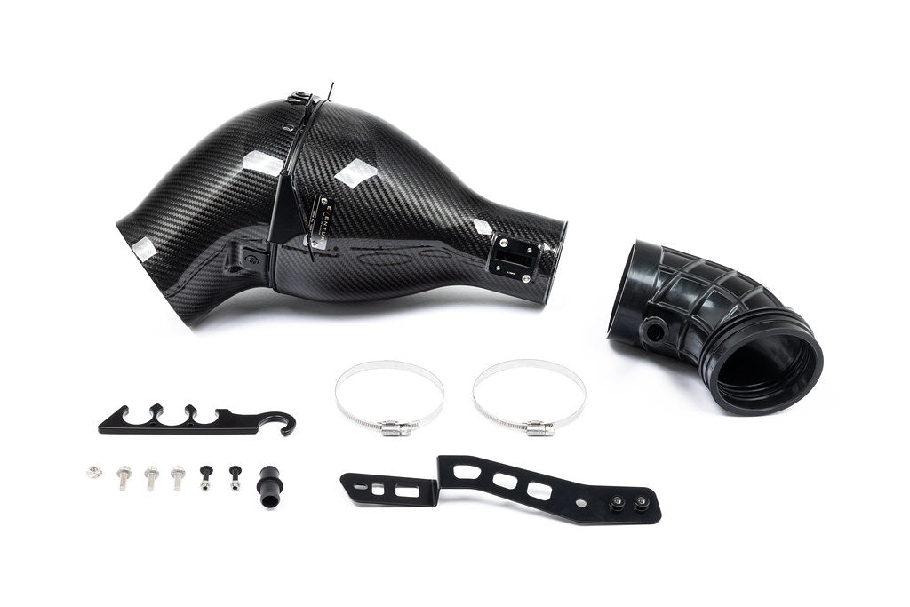 Eventuri Lotus Emira V6 black carbon intake system showcasing sleek design against a white background.