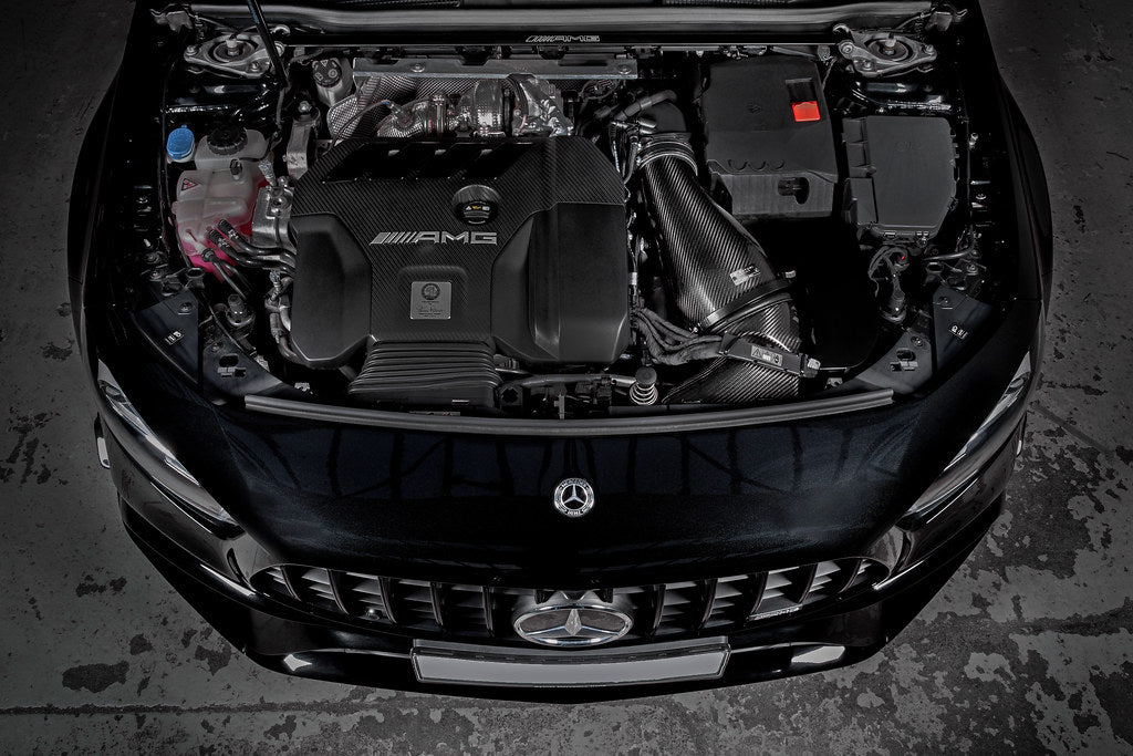 Eventuri black carbon intake system installed in engine bay of Mercedes AMG A45 and CLA45, enhancing performance and airflow.