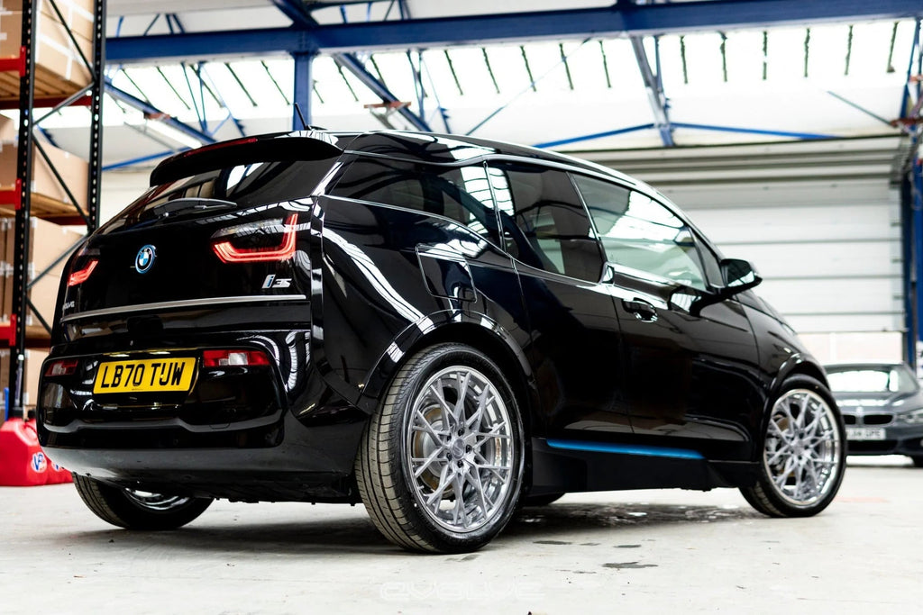 Evolve I01 i3 i3S Lowering Springs installed on a BMW i3S, reducing ride height for a more aggressive stance while preserving factory ride quality and suspension comfort.