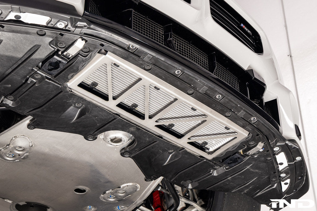Fall-Line Motorsports oil cooler guard installed on BMW G8X M2, M3, and M4 models, designed to protect the factory oil cooler from road and track debris while maintaining airflow and fitment.