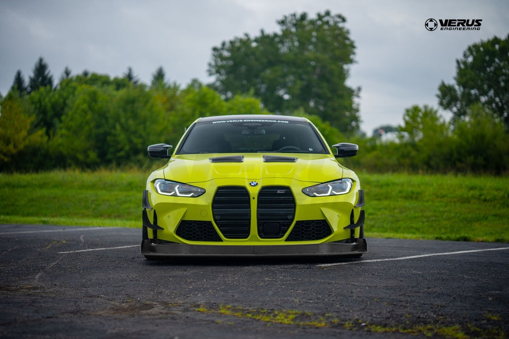 Verus Engineering G8x M3 M4 Carbon Polyweave Front Splitter Kit installed on a BMW M4, showing the sleek exterior design and aerodynamic features.