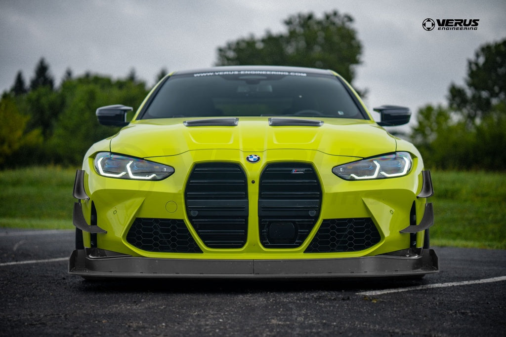 Verus Engineering G8x M3 M4 carbon polyweave front splitter kit on a BMW M4 exterior body with aerodynamic design.