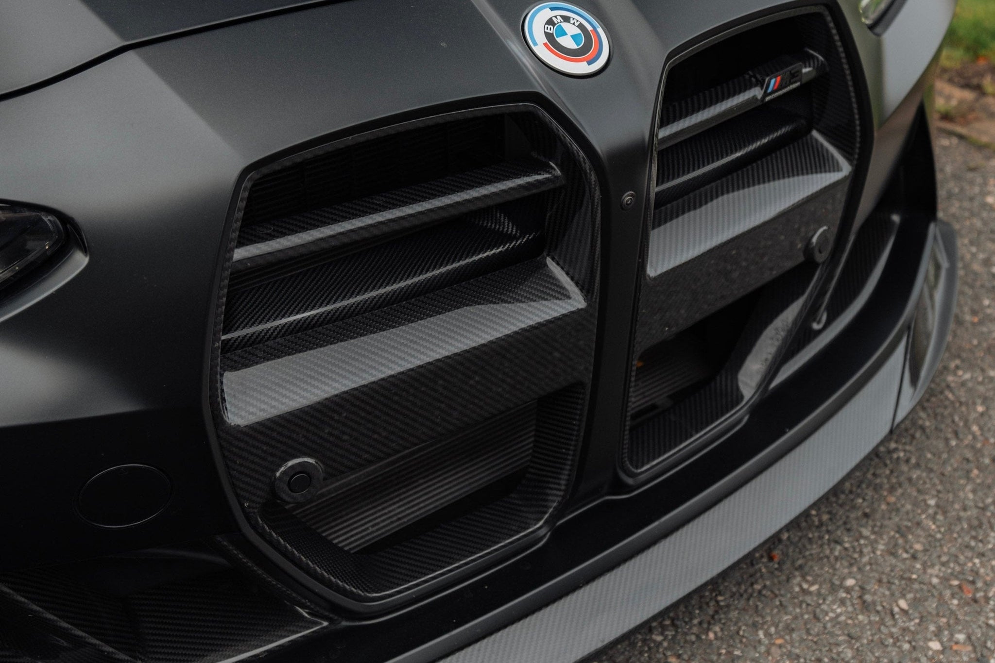 TREVORA G8X M3 M4 carbon fiber foam crash bar cover for exterior, showcasing sleek black carbon fiber finish and precise fit.