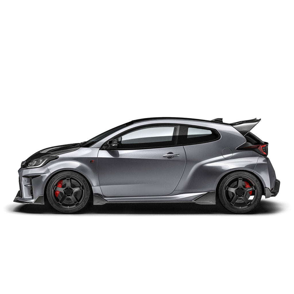 ADRO Toyota GR Yaris carbon fiber side skirts installed on exterior of vehicle, showcasing sleek, aerodynamic design.