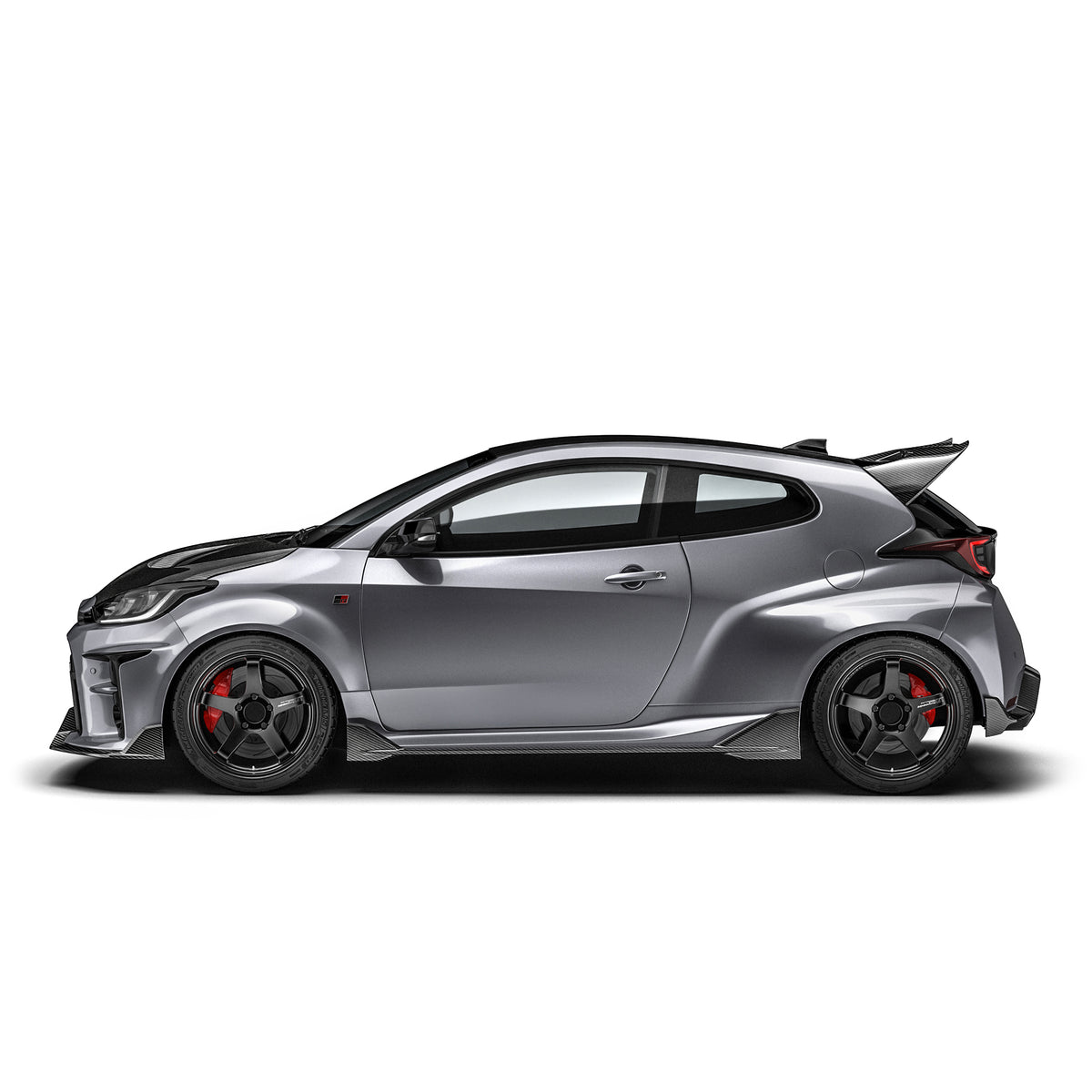 ADRO Toyota GR Yaris carbon fiber side skirts installed on exterior of vehicle, showcasing sleek, aerodynamic design.