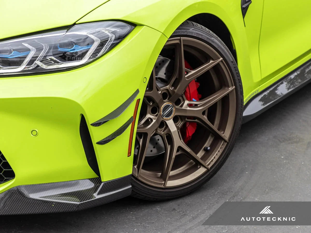AutoTecknic G8X M3 M4 dry carbon canard set installed on exterior of car, showcasing aerodynamic performance and sleek design.